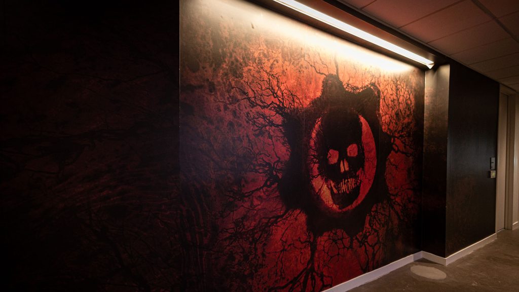 A hallway inside our studio covered in wooden planks and lite with red light.